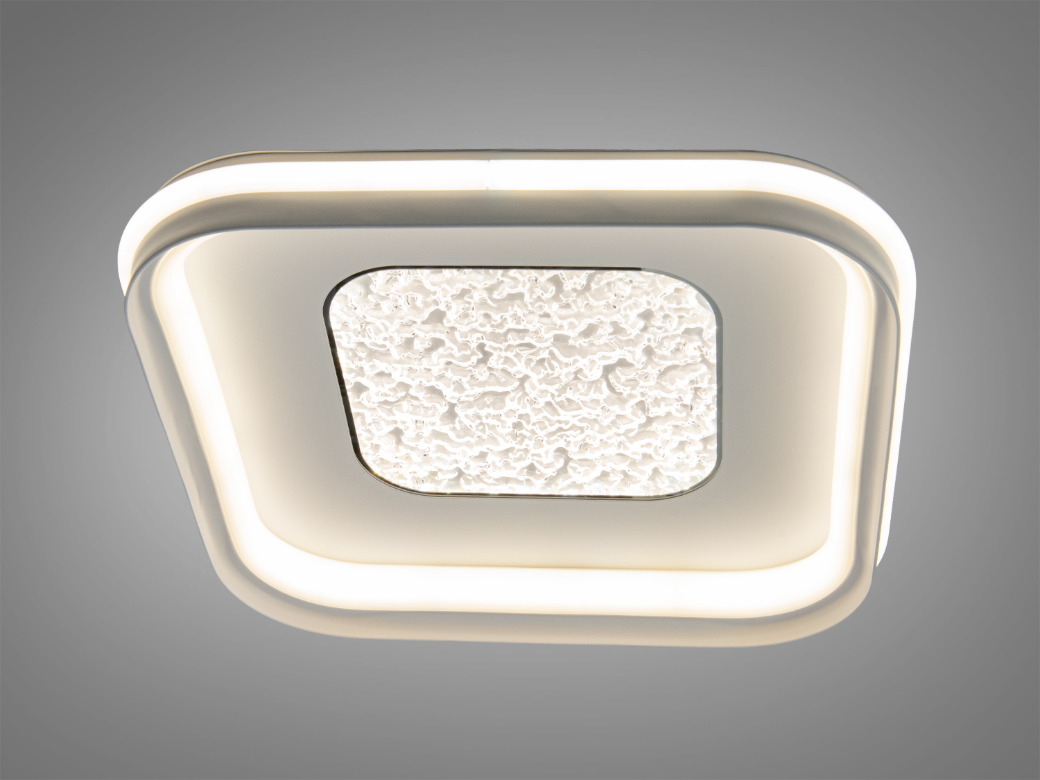 Світильник з округленими краями та текстурованою вставкою, що випромінює яскраве світло. Ідеальний для стельового монтажу в офісах.
