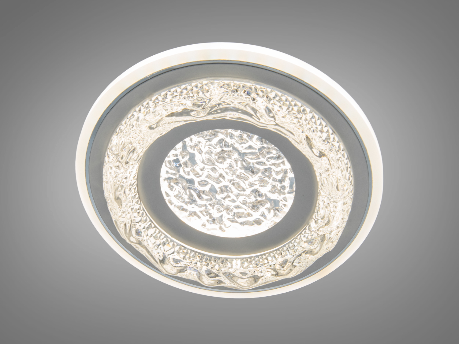 Світильник круглої форми з текстурованим скляним дифузором, що створює м′яке розсіяне світло. Ідеальний для сучасного інтер′єру.