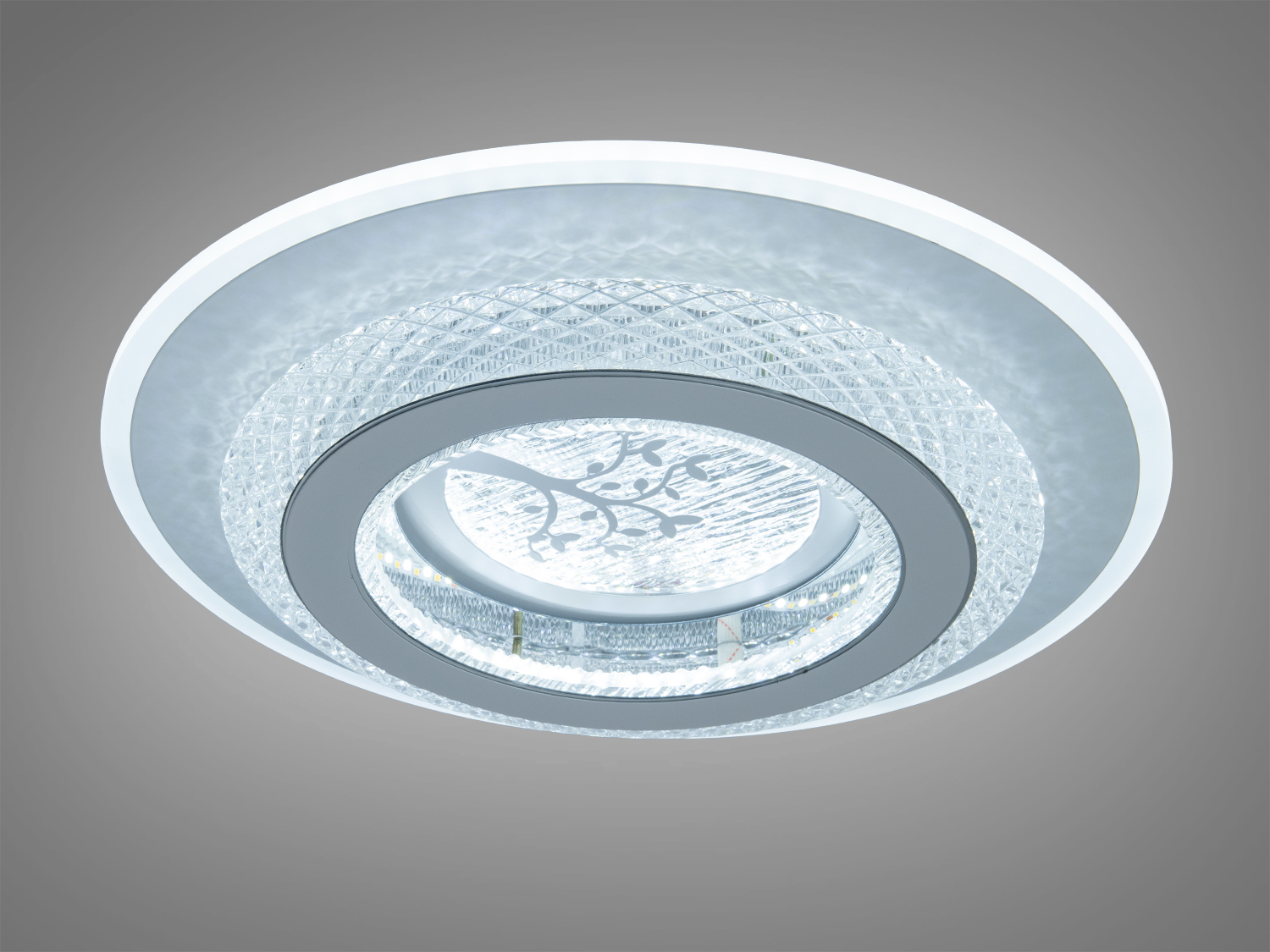 Вбудований світильник з прозорого матеріалу, що випромінює нейтральне світло, з квітковим орнаментом, підходить для стельового монтажу.