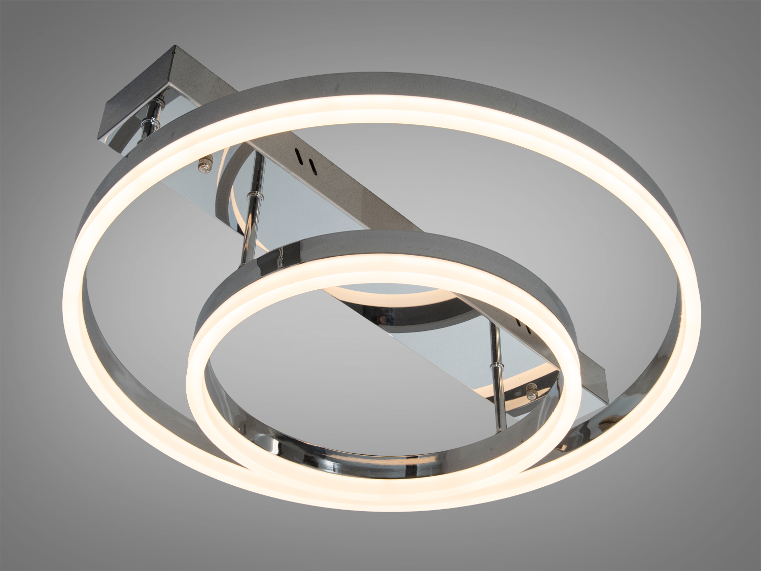 Світильник з двома круглими LED кільцями, що випромінює тепле світло. Ідеально підходить для створення затишної атмосфери.