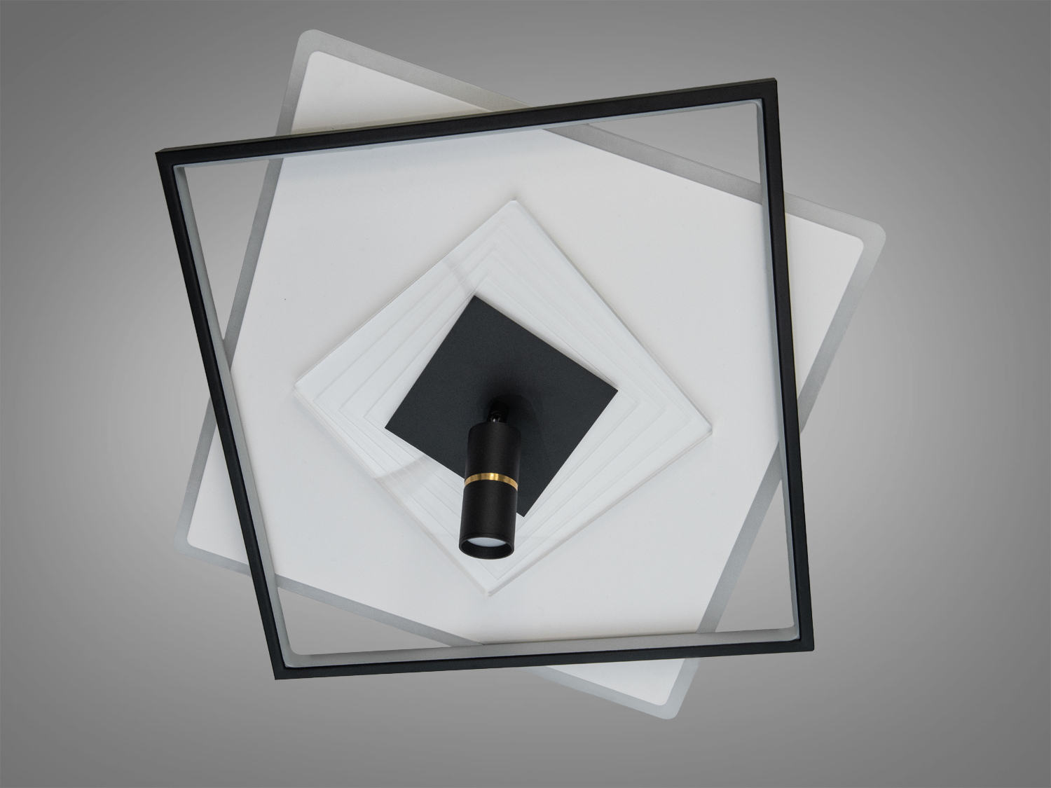 Мінімалістичний світильник з чорними квадратними рамками, що перекриваються, оснащений точковим світлом для ефективного освітлення.