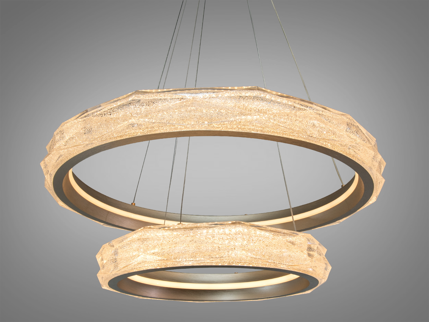 Підвісний світильник із двома кільцями, що випромінюють тепле світло. Ідеально підходить для затишних приміщень.