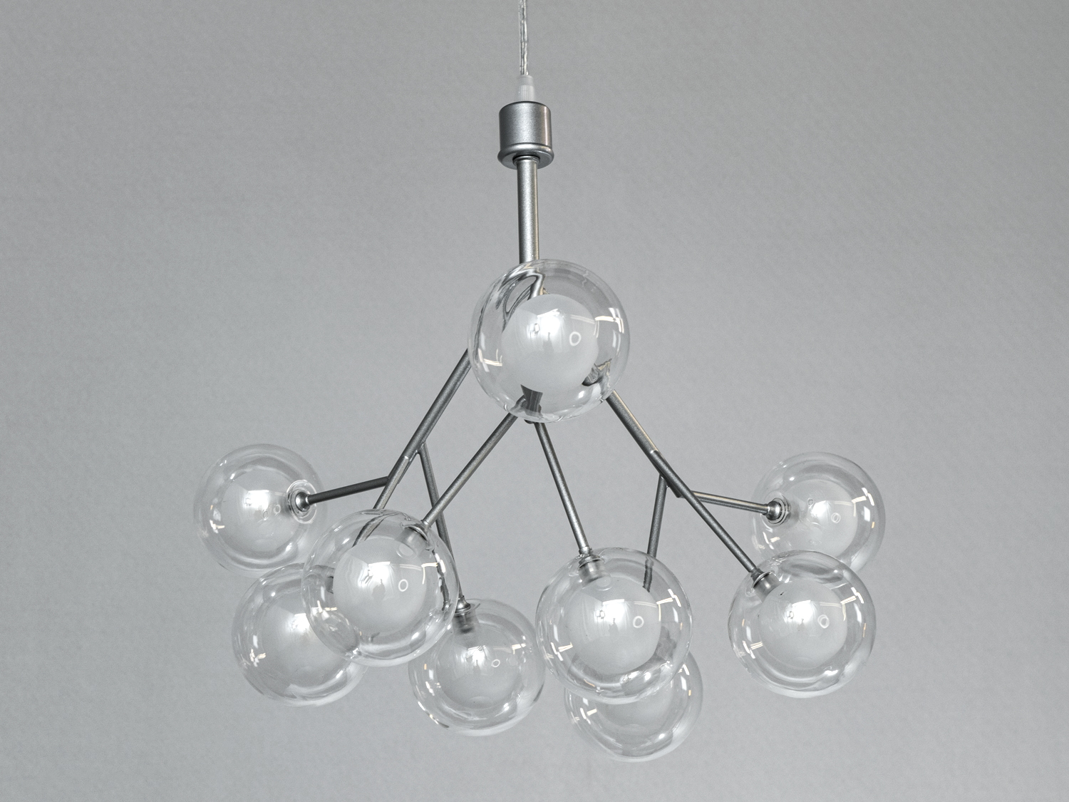 Стельова люстра з прозорими скляними кулями, що випромінюють рівномірне світло. Встановлюється на стелю за допомогою кріплення.