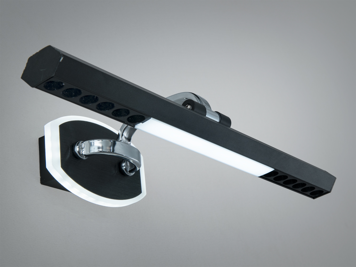 Світильник з чорним корпусом і хромованими елементами, призначений для настінного монтажу, підходить для сучасного декору.