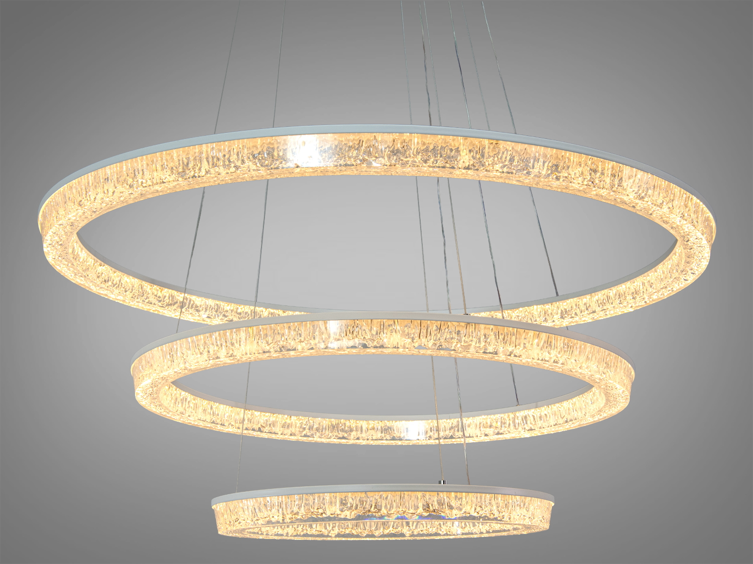 Люстра з трьома підвісними кільцями, що випромінюють тепле світло. Прозорі елементи забезпечують рівномірний розподіл світла, ідеально для вітальні.