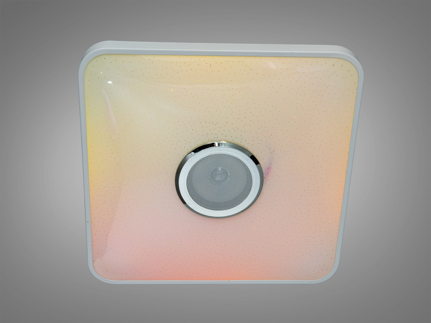 Квадратна лампа з динаміком, що випромінює тепле жовте світло. Ідеальна для затишного освітлення вітальні.