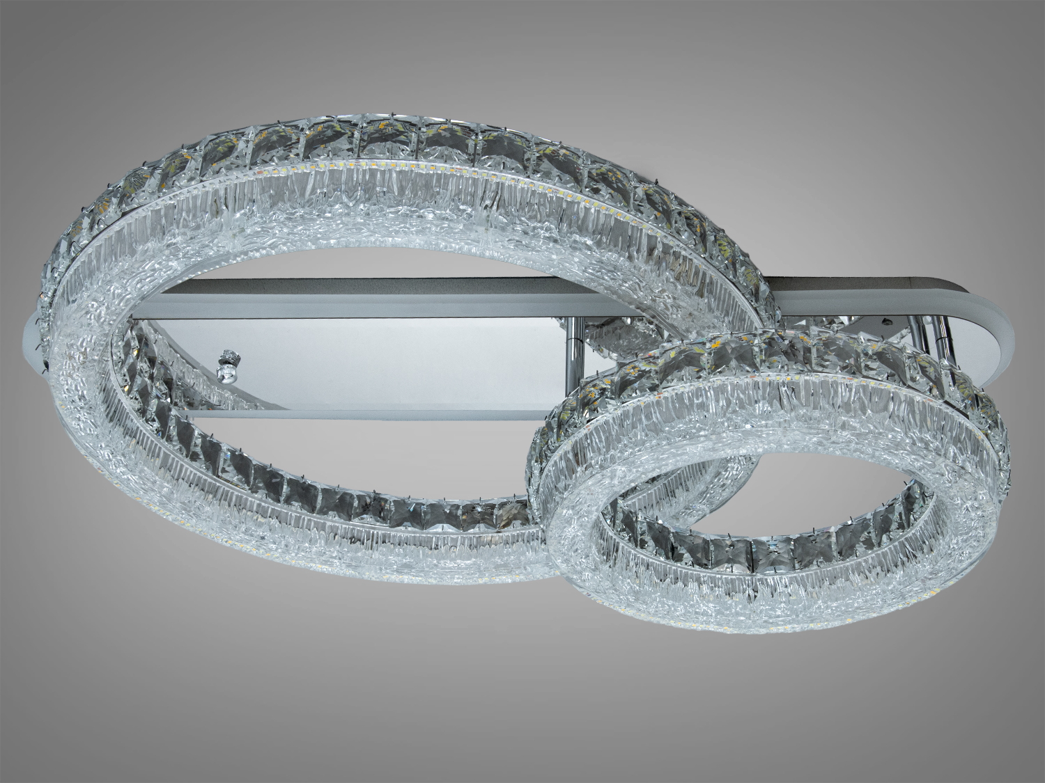 Світильник з двома кільцями, що переплітаються, на металевій основі. Прозорий акрил кілець додає елегантності для сучасного інтер′єру.