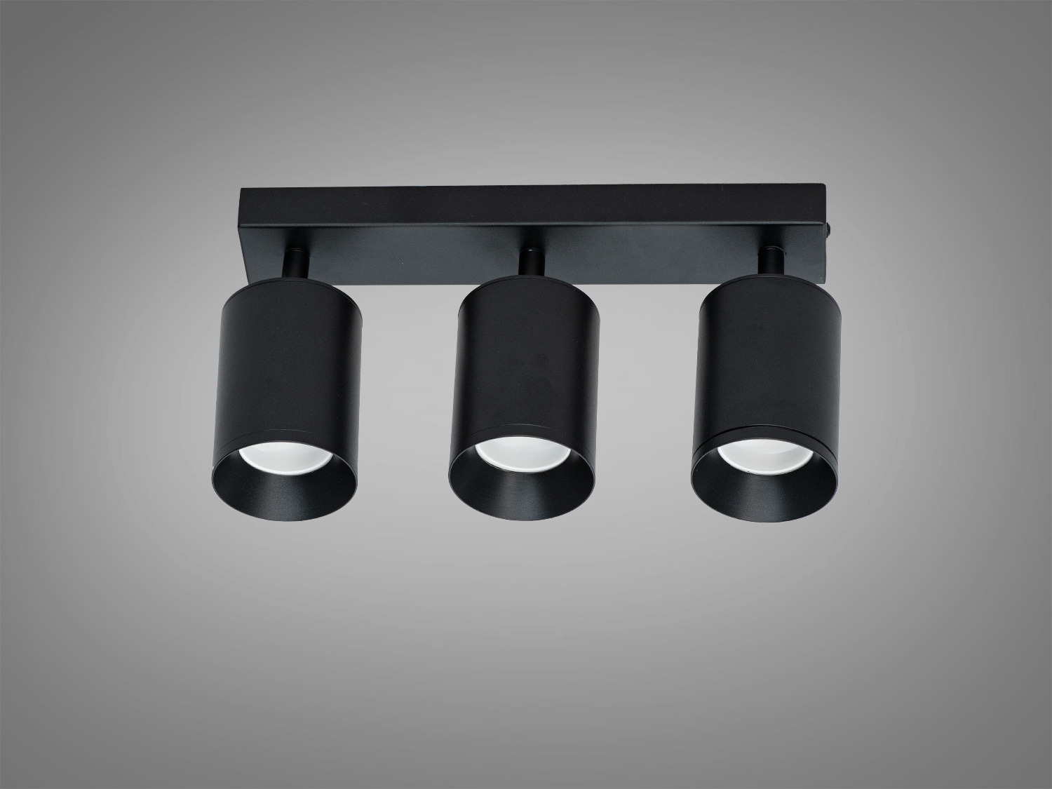 Стельовий світильник чорного кольору з трьома циліндричними лампами, призначений для монтажу на стелю в сучасних приміщеннях.