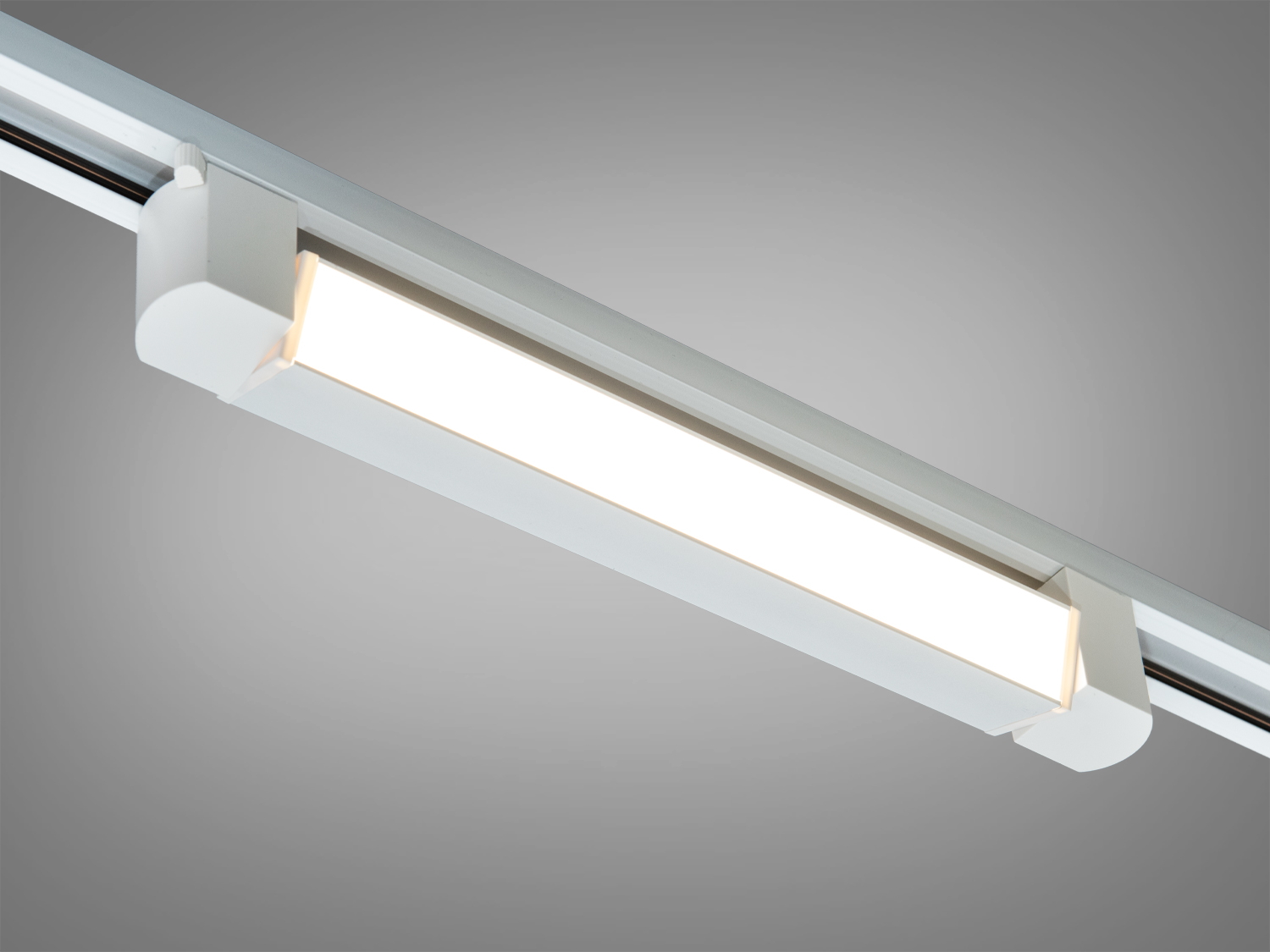 Світлодіодний світильник для трекової системи, білий корпус. Випромінює тепле світло, підходить для сучасних інтер′єрів.