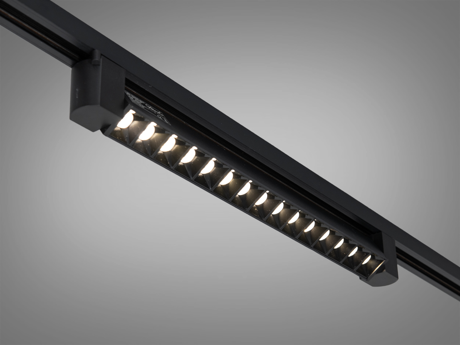 Чорний трековий світильник з вбудованими LED-лампами, які створюють м′яке освітлення. Підходить для сучасних інтер′єрів.