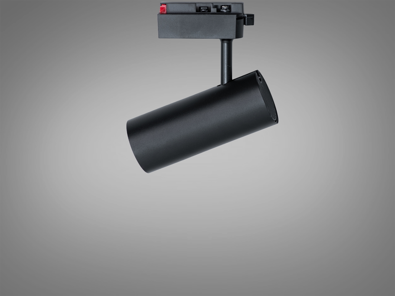 Чорний трековий світильник циліндричної форми з компактним кріпленням, підходить для сучасних інтер′єрів з мінімалістичним дизайном.