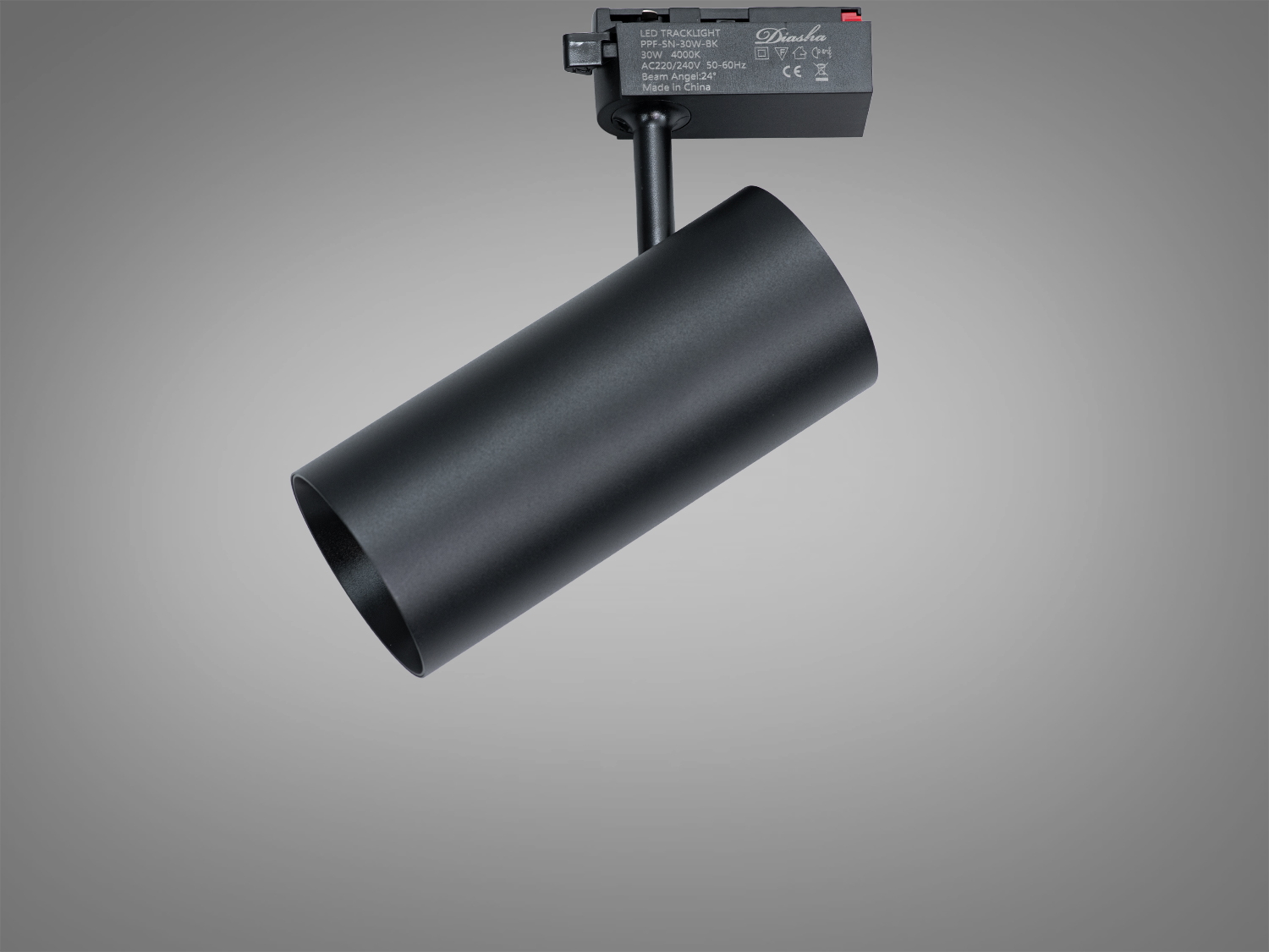 Циліндричний трековий світильник чорного кольору, зручний для монтажу на стелі, забезпечує спрямоване освітлення.