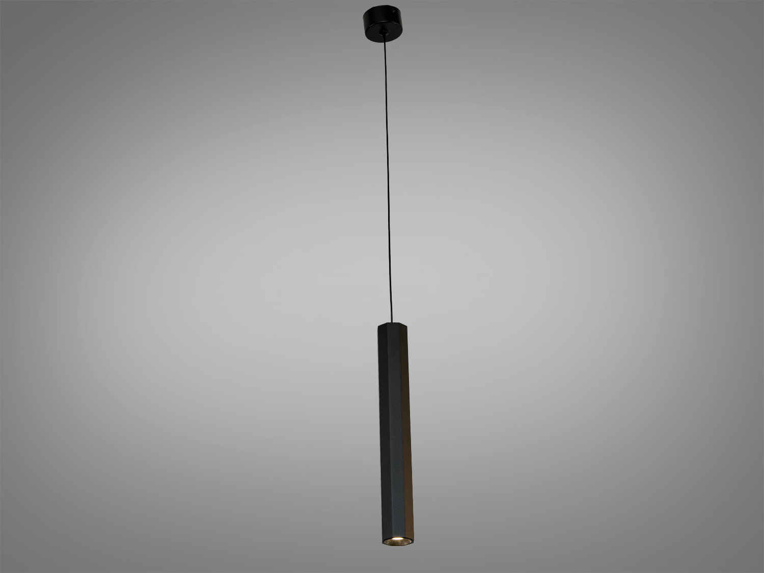 Чорний підвісний світильник з вузьким циліндричним корпусом, що випромінює спрямоване світло вниз. Ідеальний для акцентного освітлення.