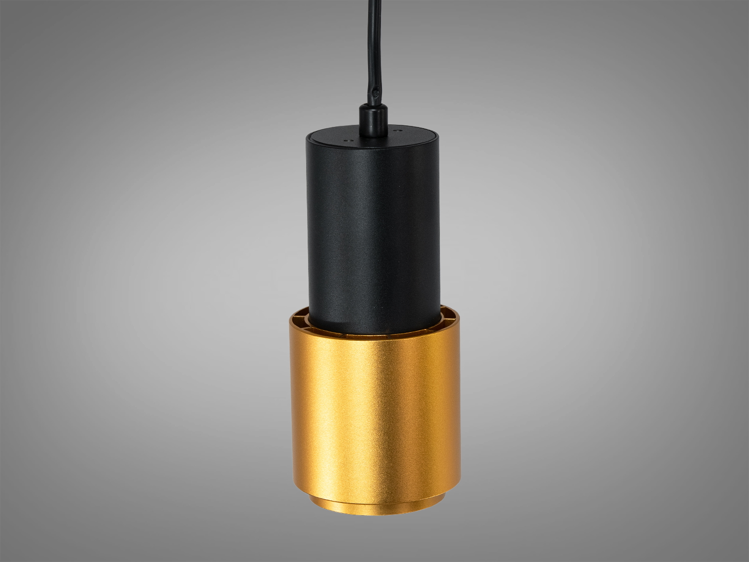 Світильник циліндричної форми з верхнім кріпленням, чорний корпус, золотистий акцент.