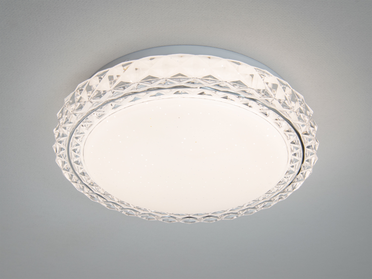 Стельовий світильник з круглим корпусом і прозорим візерунковим краєм, що забезпечує рівномірне освітлення в сучасних приміщеннях.