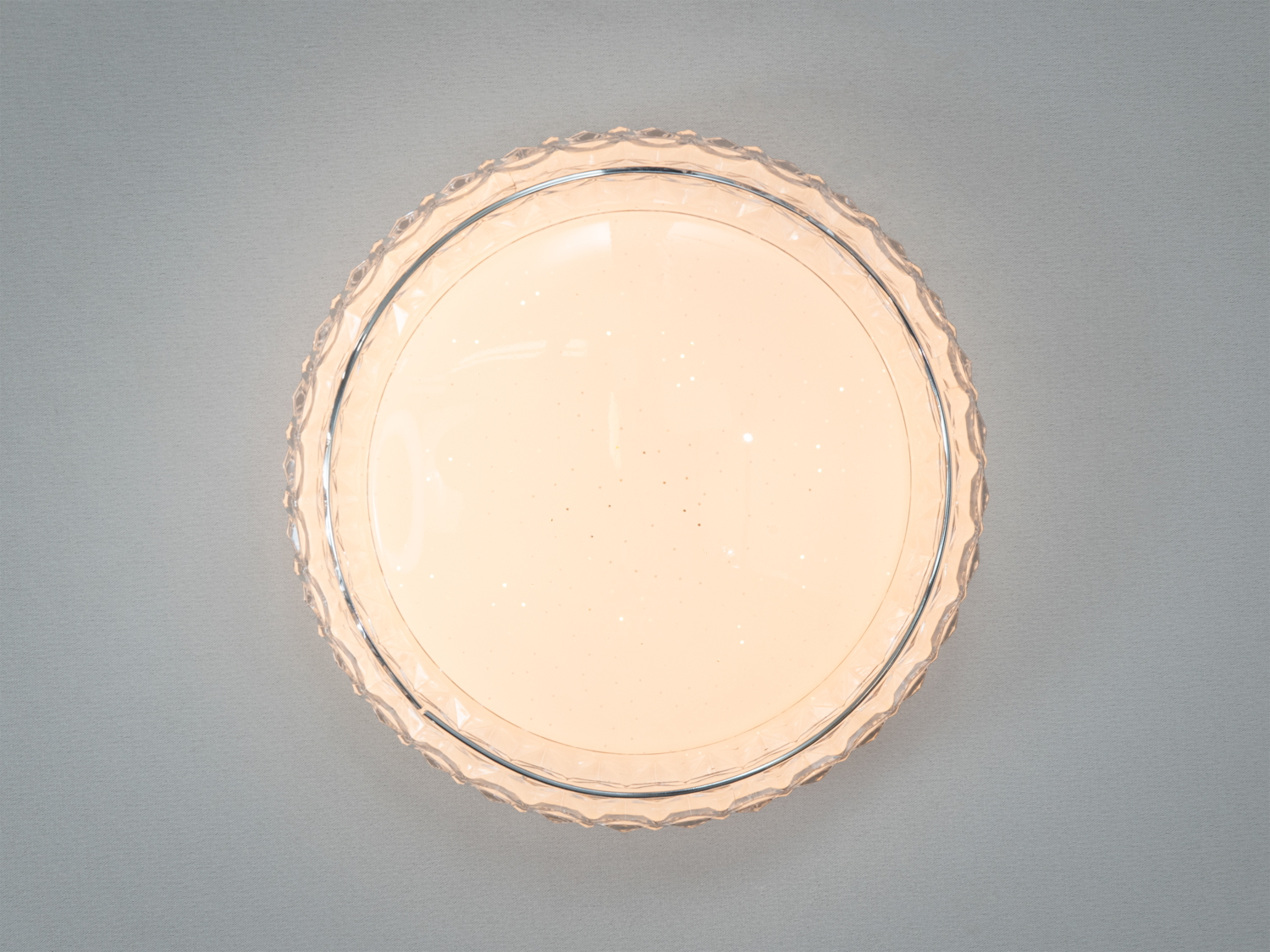 Круглий світильник з візерунковим прозорим обідком, що підходить для монтажу на стелі, забезпечуючи м′яке освітлення.