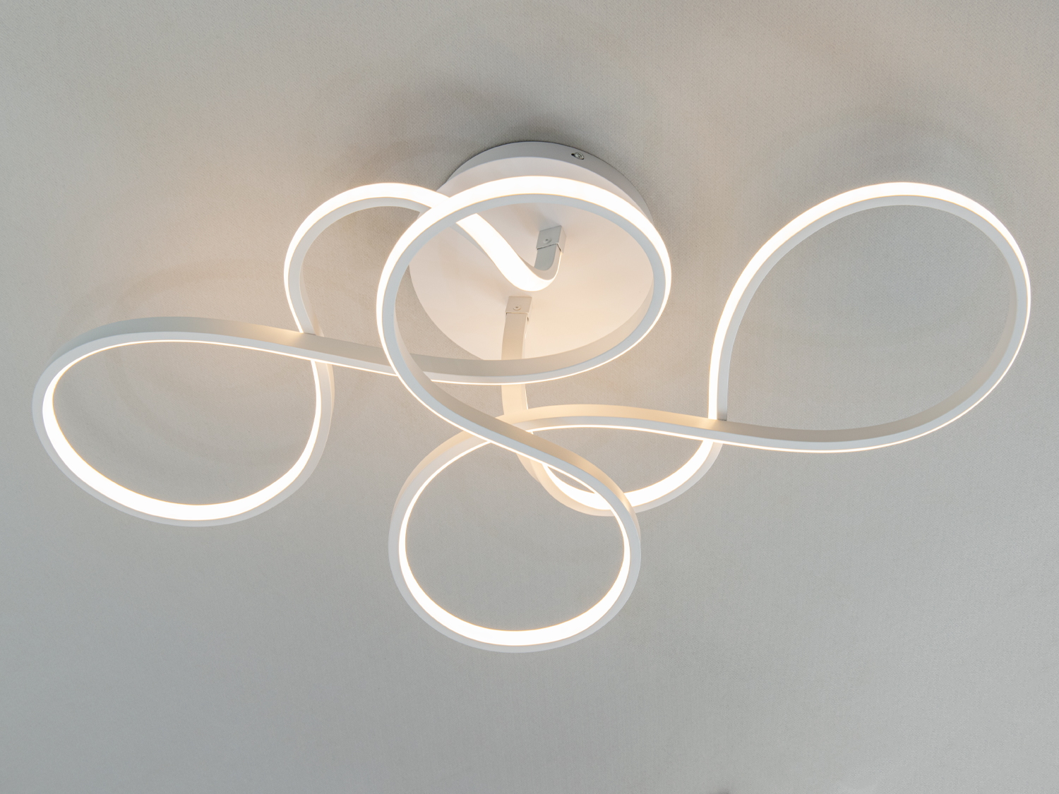 Дизайнерський світильник з плавними LED-смугами, стельове кріплення, підходить для сучасних віталень, створює затишну атмосферу.